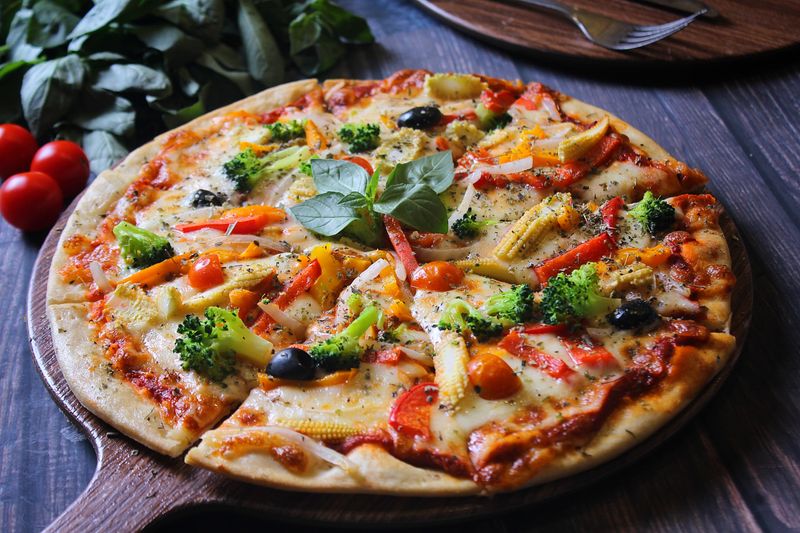 Verde pizza with fresh green vegetables and pesto
